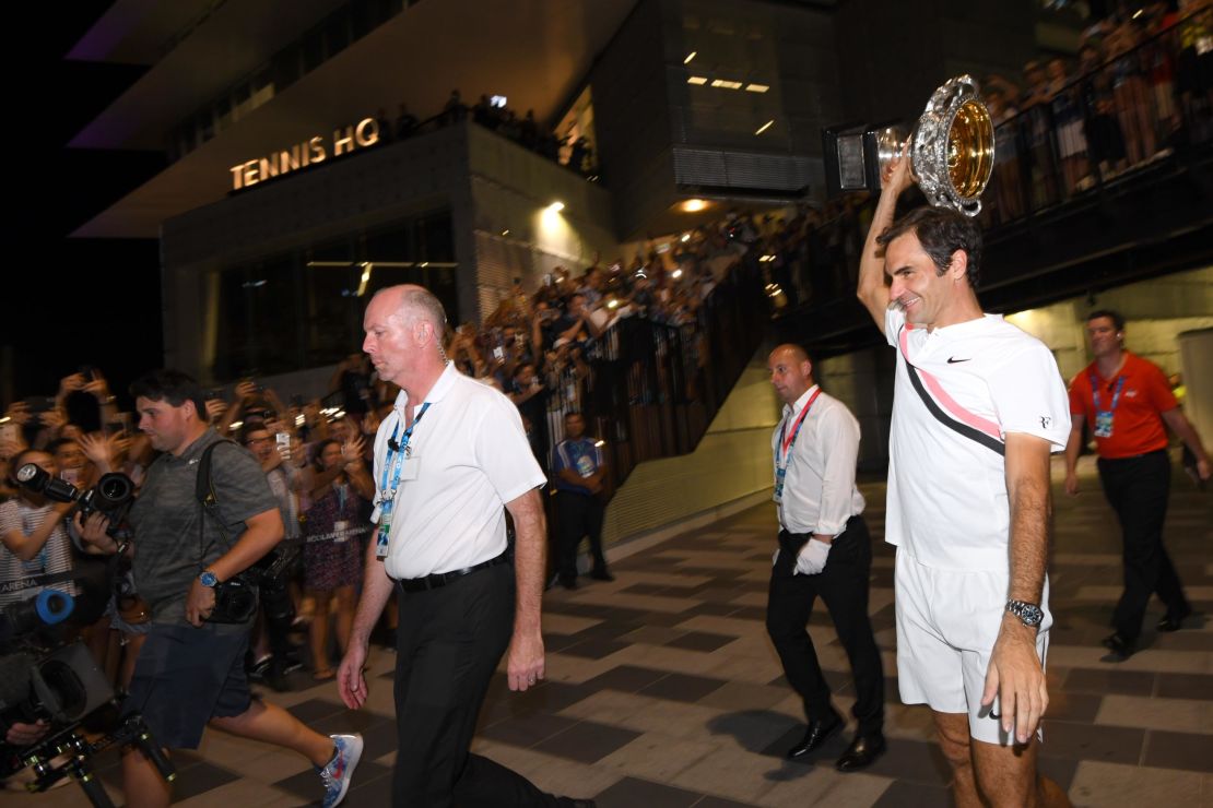 Roger Federer takes his trophy on a tour. 