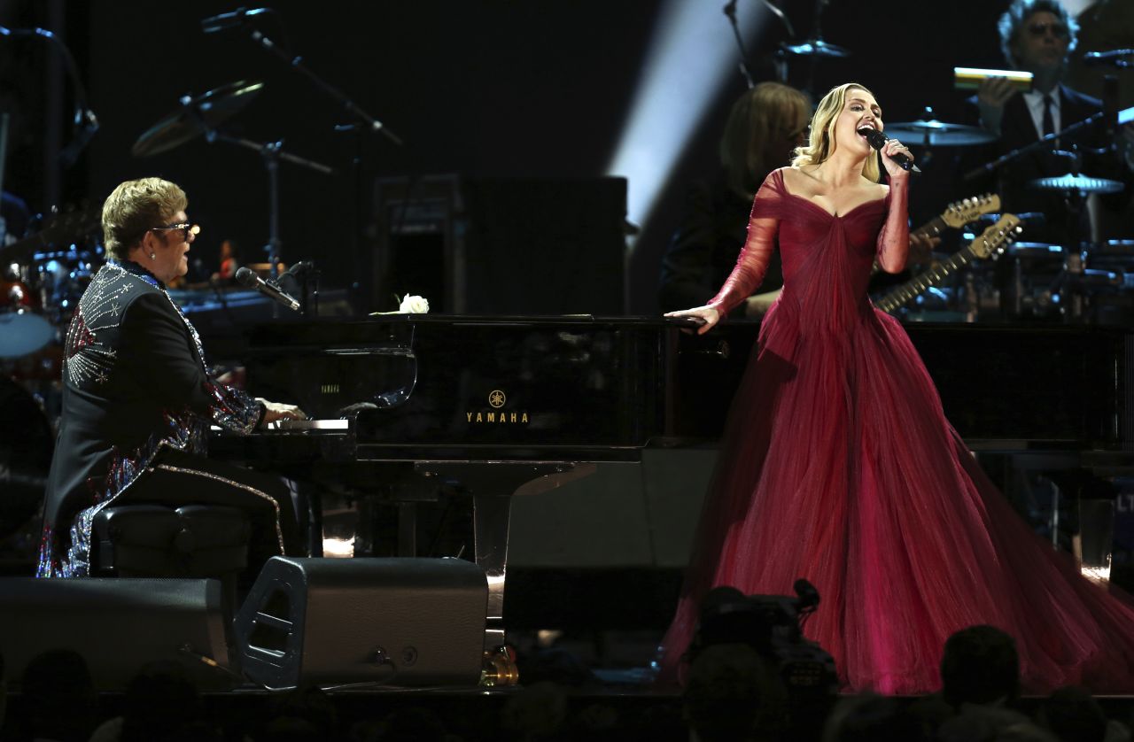 Elton John and Miley Cyrus team up for John's "Tiny Dancer."