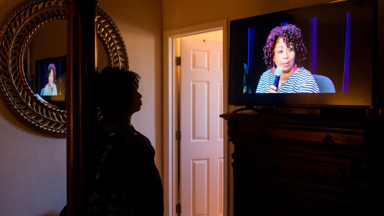 Johnson has become a public speaker on child marriage. Here, she watches a video of herself at a recent panel discussion sponsored by the Tahirih Justice Center.