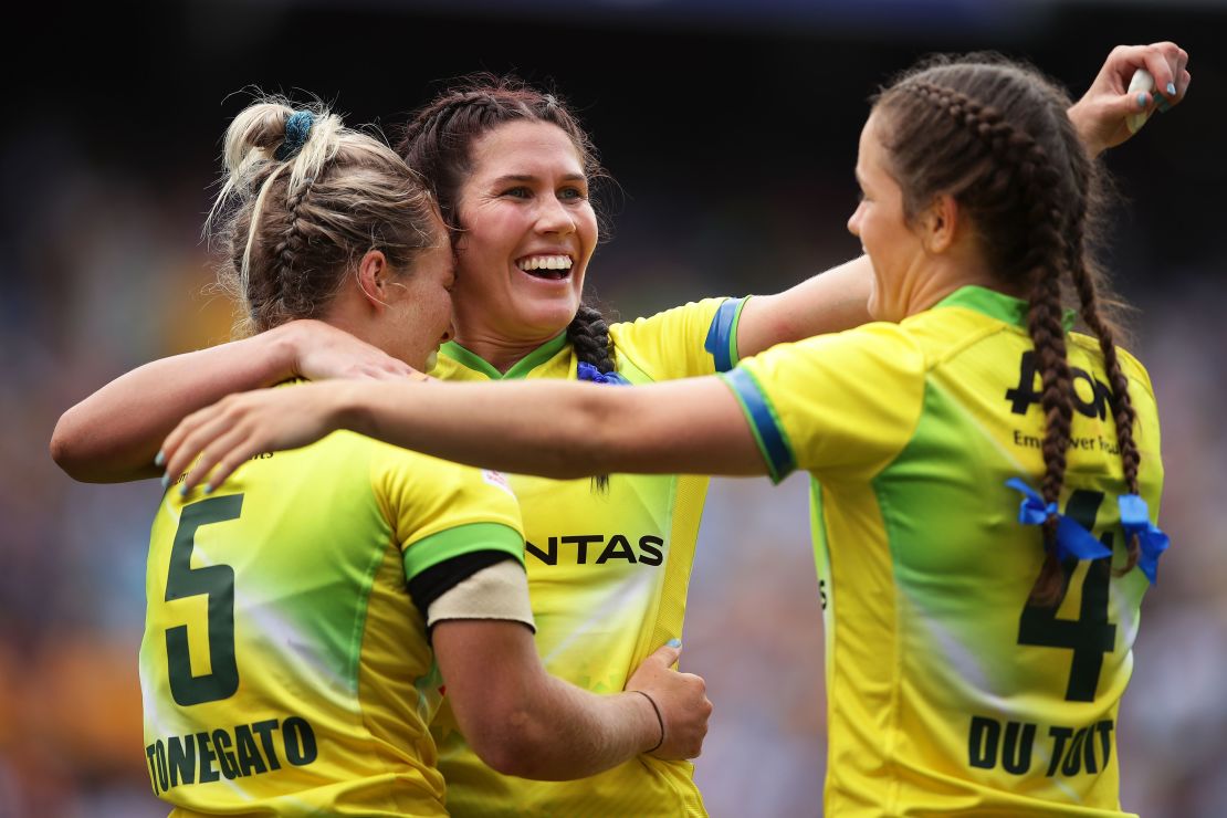 Australia's Emma Tonegato (L), Charlotte Caslick (C) and Dominique Du Toit (R) celebrate beating New Zealand in the final of the Sydney Sevens. 