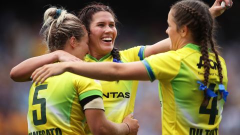 Australia's Emma Tonegato (L), Charlotte Caslick (C) and Dominique Du Toit (R) celebrate beating New Zealand in the final of the Sydney Sevens. 