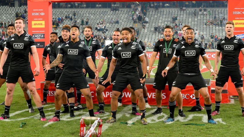 New Zealand's players celebrate with the trophy after winning the World Rugby Sevens Series at Cape Town Stadium on December 10, 2017 in Cape Town. / AFP PHOTO / RODGER BOSCH (Photo credit should read RODGER BOSCH/AFP/Getty Images)