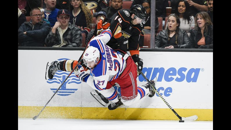 New York Rangers defenseman Ryan McDonagh, bottom, checks Anaheim center Adam Henrique during an NHL game on Tuesday, January 23.