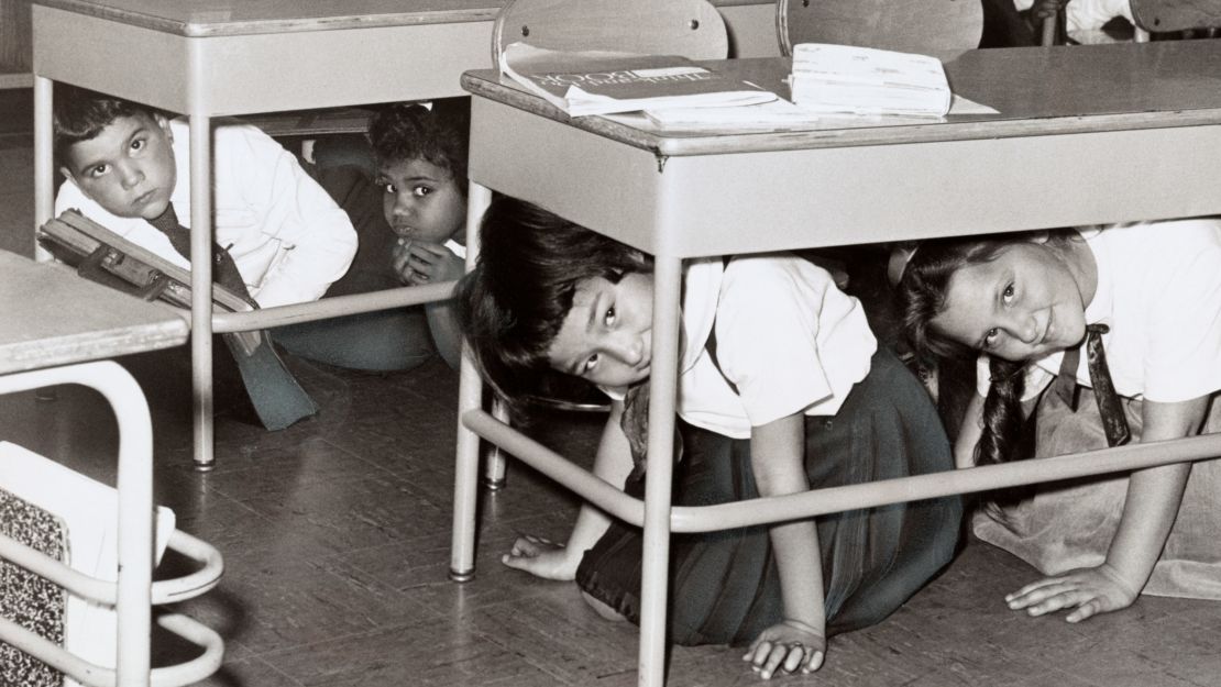 Students at a Brooklyn middle school have a 'duck and cover' practice drill in preparation for a nuclear attack in 1962.