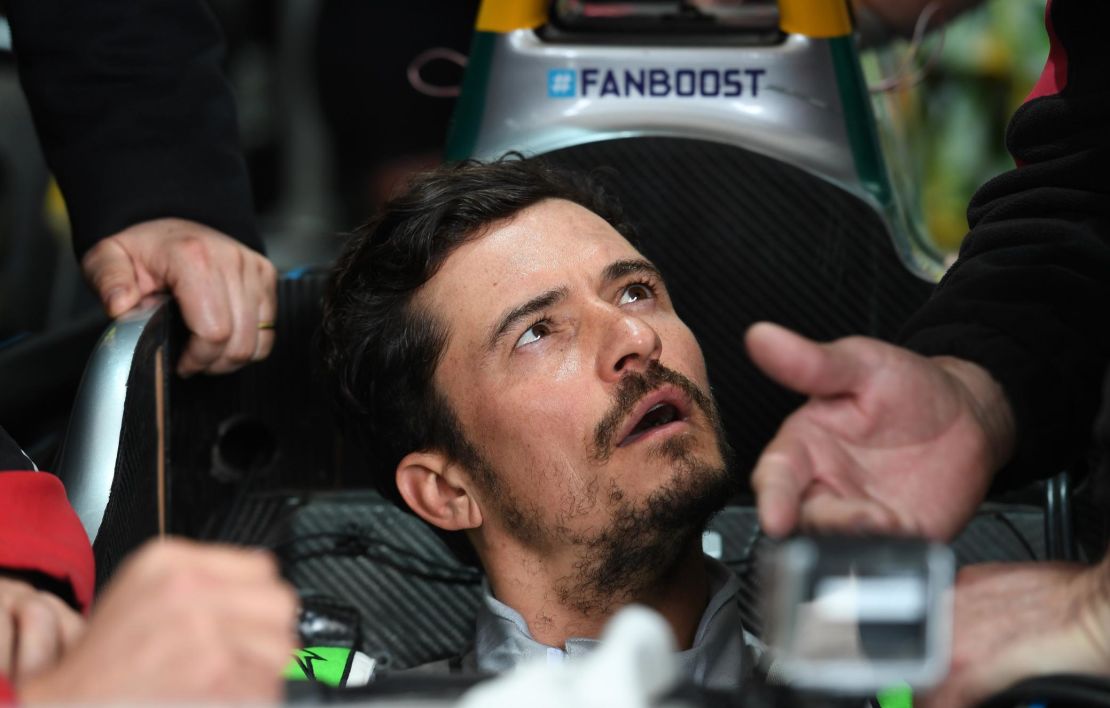 Orlando Bloom receives some instructions between taking to the track.