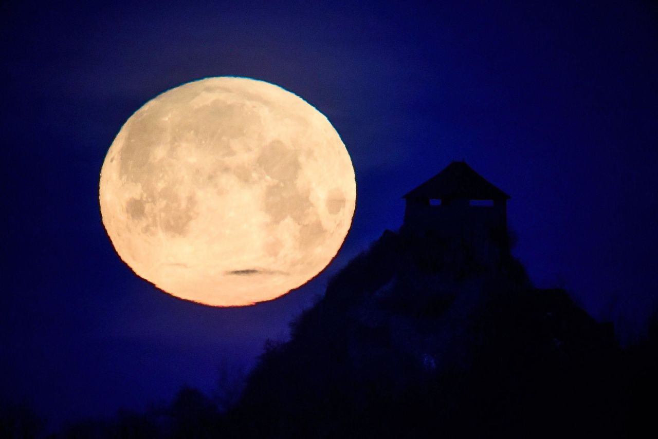 The supermoon silhouettes Fort Salgo in Salgotarjan, Hungary.