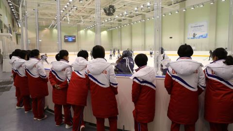 North Korea's women's ice hockey players watch South Korea's women's team train on January 26, 2018.