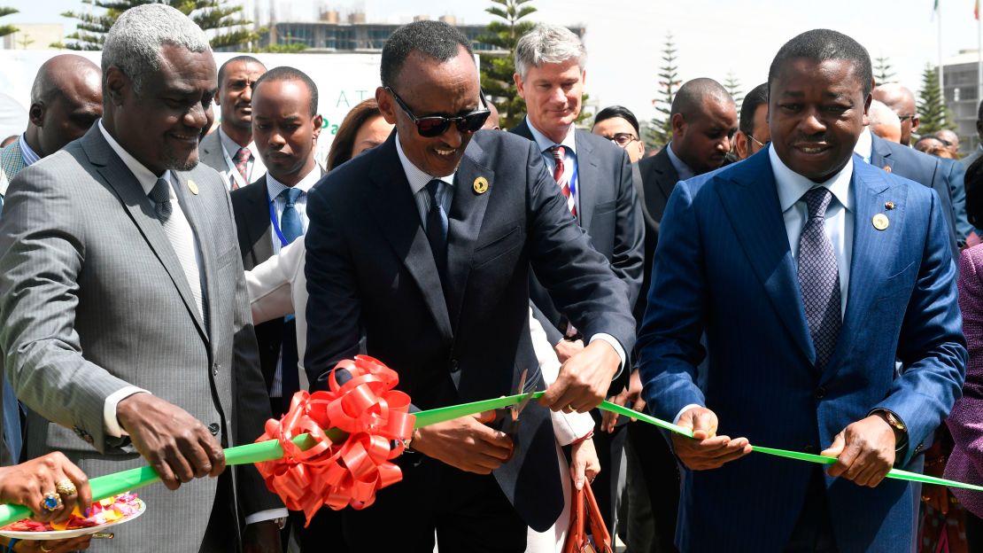 Rwandan President and Chairperson of the African Union, Paul Kagame flanked by Togo President Faure Gnassingbe and Chairperson of African Union Commission Moussa Faki Mahamat, cuts a ribbon during a launch of the Single African Air Transport Market.