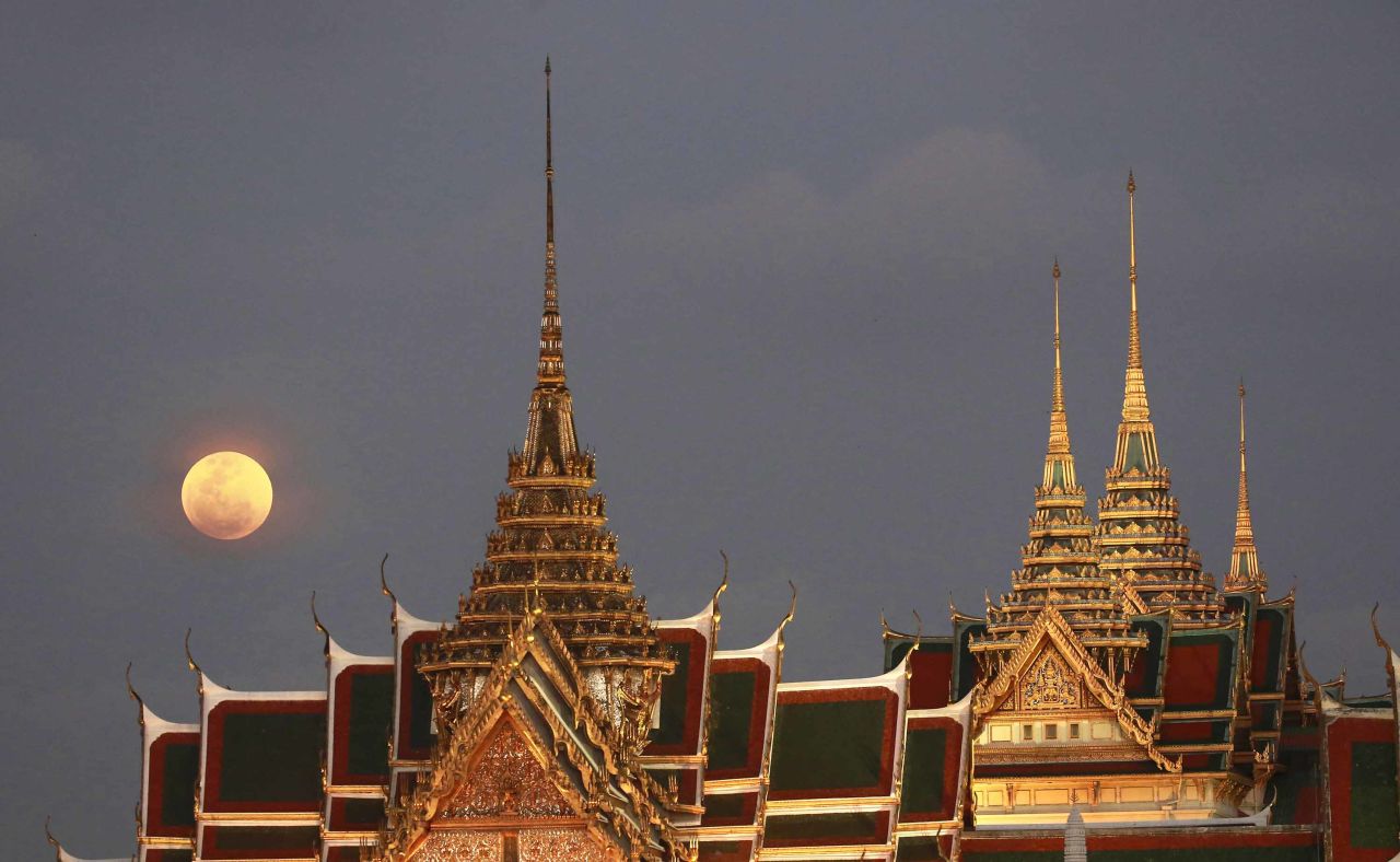 The supermoon is seen above the Grand Palace in Bangkok, Thailand.