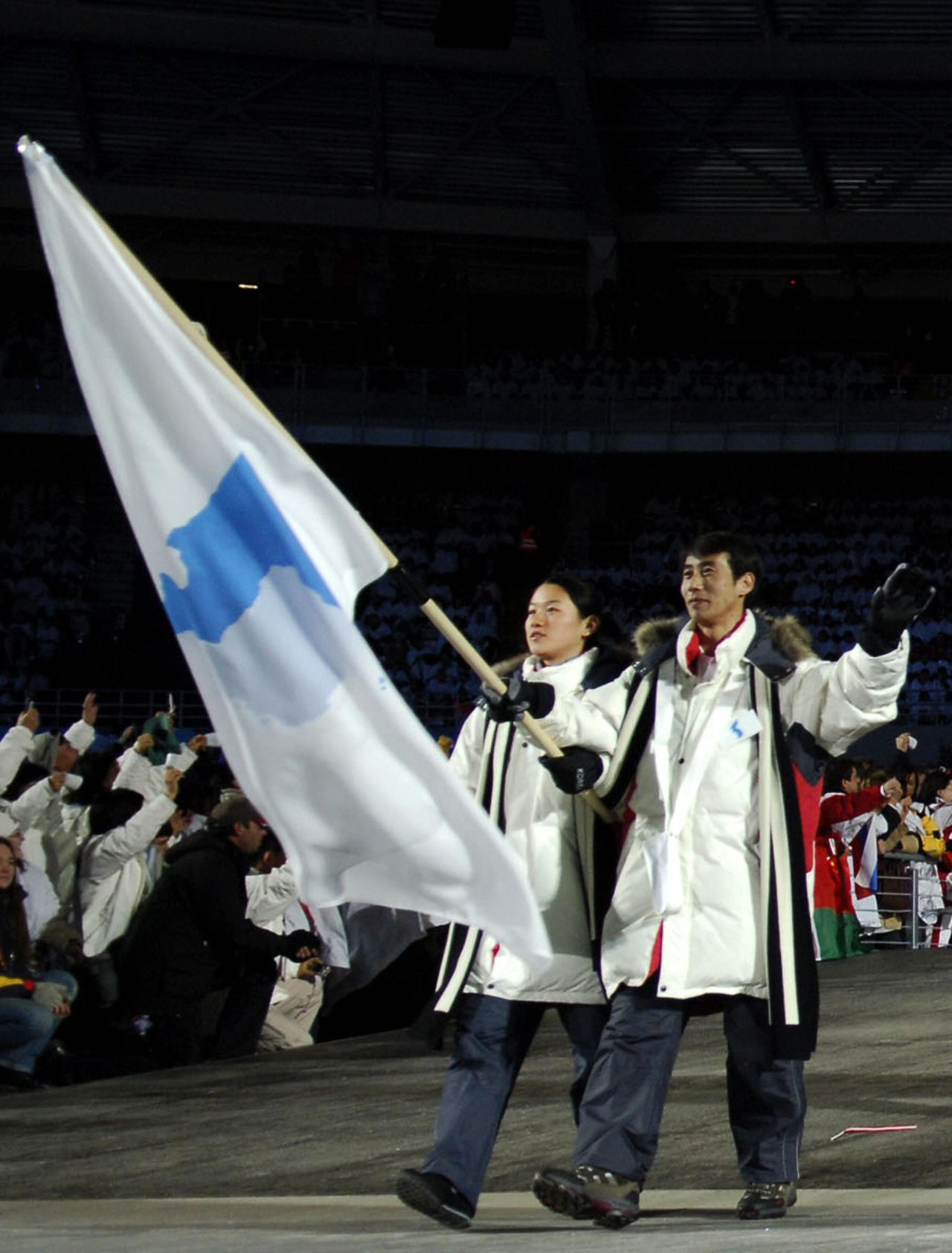 South Korean speed skater  Lee Bora (left) and North Korean figure skater Han Jong-In lead their delegation as they arrive for the opening ceremony of the 2006 Winter Olympics at the Olympic stadium in Turin, Italy.
