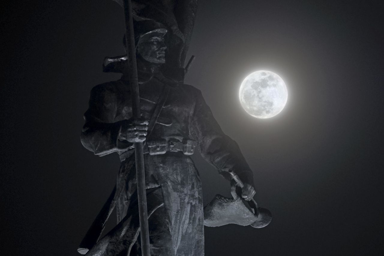 The full moon shines over a monument in Vladivostok, Russia.