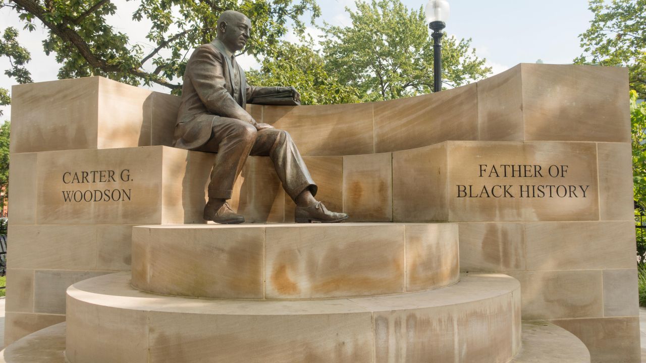 <strong>Carter G. Woodson Park, Washington, D.C.:</strong> In the Shaw neighborhood, a triangular park and bronze sculpture of Woodson seated on a circular stone memorial commemorates his legacy.