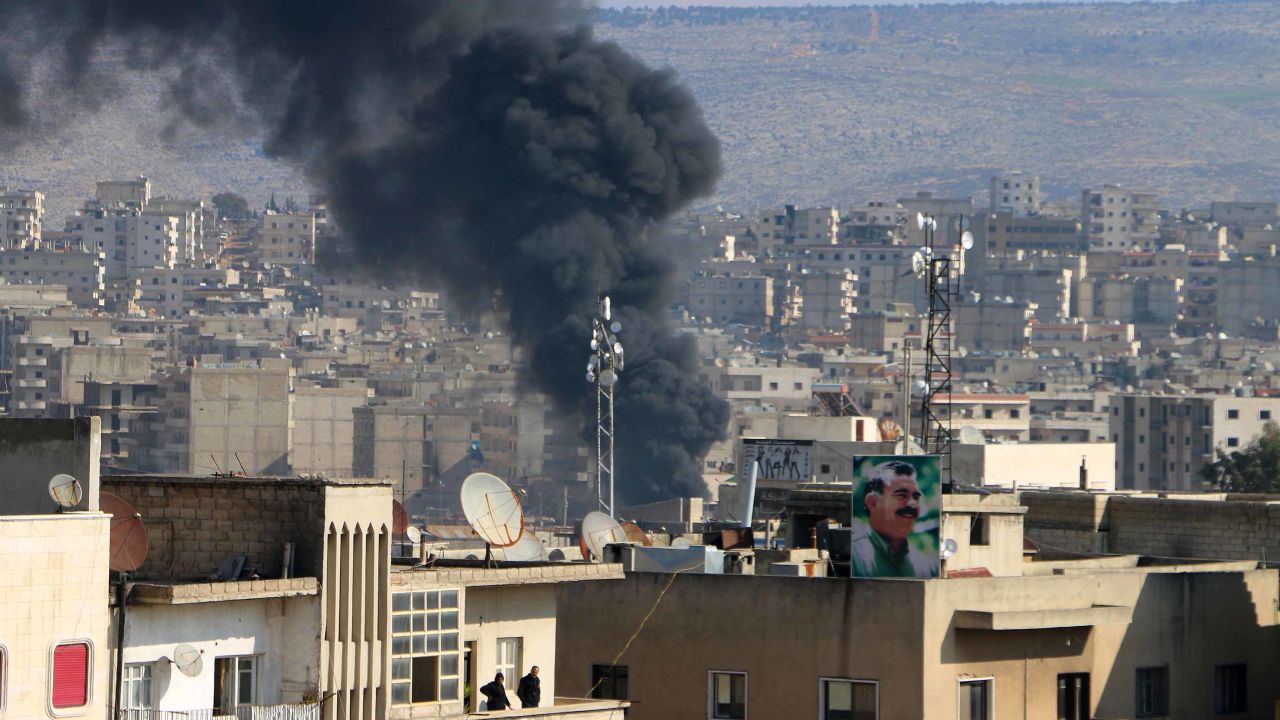 A plume of smoke billows over Afrin as bombardment continues.