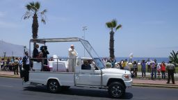 Pope Francis waves from the popemobile to the people in the streets of the Chilean northern city of Iquique, after celebrating an open-air mass at the nearby Lobitos Beach on January 18, 2018.Pope Francis closed his visit to Chile with the open-air mass near Iquique and will leave for Peru in the afternoon on the last leg of his South American trip. / AFP PHOTO / IGNACIO MUNOZ        (Photo credit should read IGNACIO MUNOZ/AFP/Getty Images)