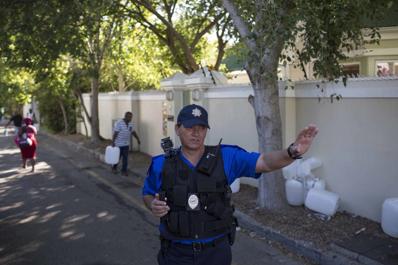 A police officer controls water collection on February 1.