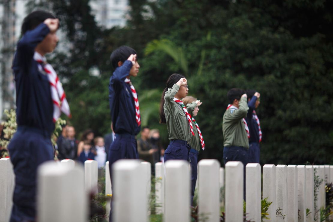 Members of the 1st Hong Kong Canadian Scouts Group salute  during the Canadian Commemorative Ceremony honouring those who died during the Battle of Hong Kong and World War II in December 2016.