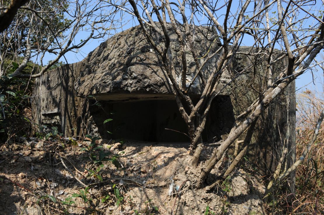 An abandoned concrete pillbox defense stands on Hong Kong island, overlooking the entrance to Victoria Harbour.