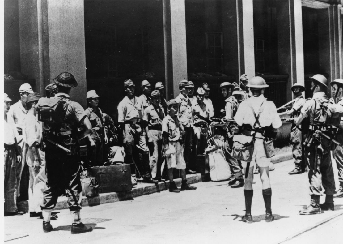 Japanese troops being rounded up by British forces in Hong Kong's dockyards in 1945.