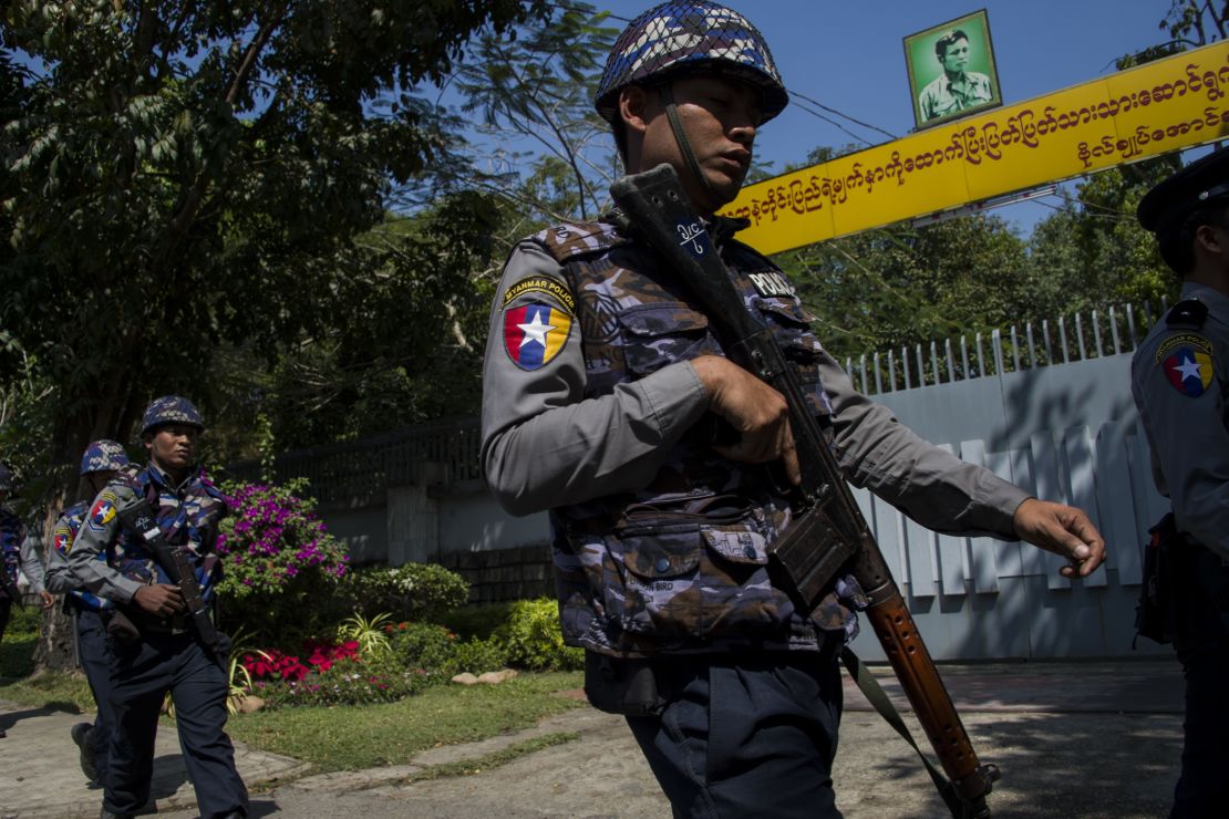 Police officers patrol in front of Suu Kyi's residence in Yangon on February 1, after a petrol bomb was hurled at it.