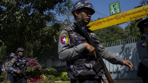 Police officers patrol in front of Suu Kyi's residence in Yangon on February 1, after a petrol bomb was hurled at it.