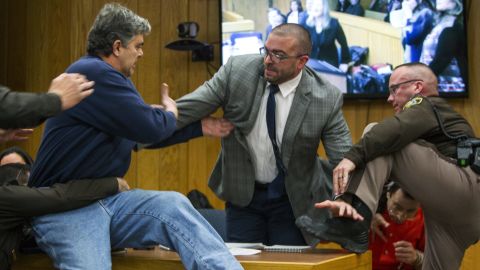 Randall Margraves, father of three victims of Larry Nassar, lunged at Nassar, bottom right, on Friday.