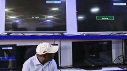 epa06489825 A Kenyan man sits in front of black screens showing a 'No Signal' message on what is supposed to be three of Kenya's local TV channels taken off air, at an electronics shop in Nairobi, Kenya, 01 February 2018. Kenya's three private TV stations -- NTV, KTN and Citizen TV -- reportedly were taken off air on 31 January following their live coverage of the opposition?s ceremony to 'swear-in' their leader Raila Odinga who lost a disputed presidential election in late 2017. Interior minister Fred Matiangi said the broadcasters will remain shut until the investigations into their links with opposition is completed. The country's High Court on 01 February suspended the shutdown for 14 days until the case is determined, local media reported. Kenyan media industry has denounced the move, terming it 'unprecedented'.  EPA-EFE/DANIEL IRUNGU