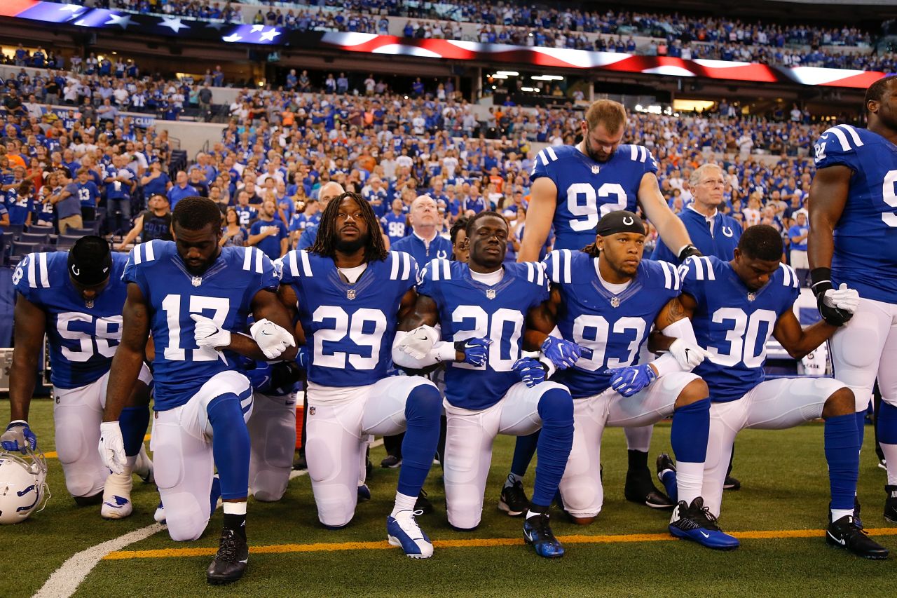 That same day, members of the Indianapolis Colts take a knee during the National Anthem ahead of their game against Cleveland Browns at Lucas Oil Stadium in Indianapolis.