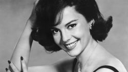 circa 1960:  American actor Natalie Wood, wearing a black evening dress, smiles while posing in a promotional portrait for director Michael Anderson's film, 'All the Fine Young Cannibals'.  (Photo by Hulton Archive/Getty Images)