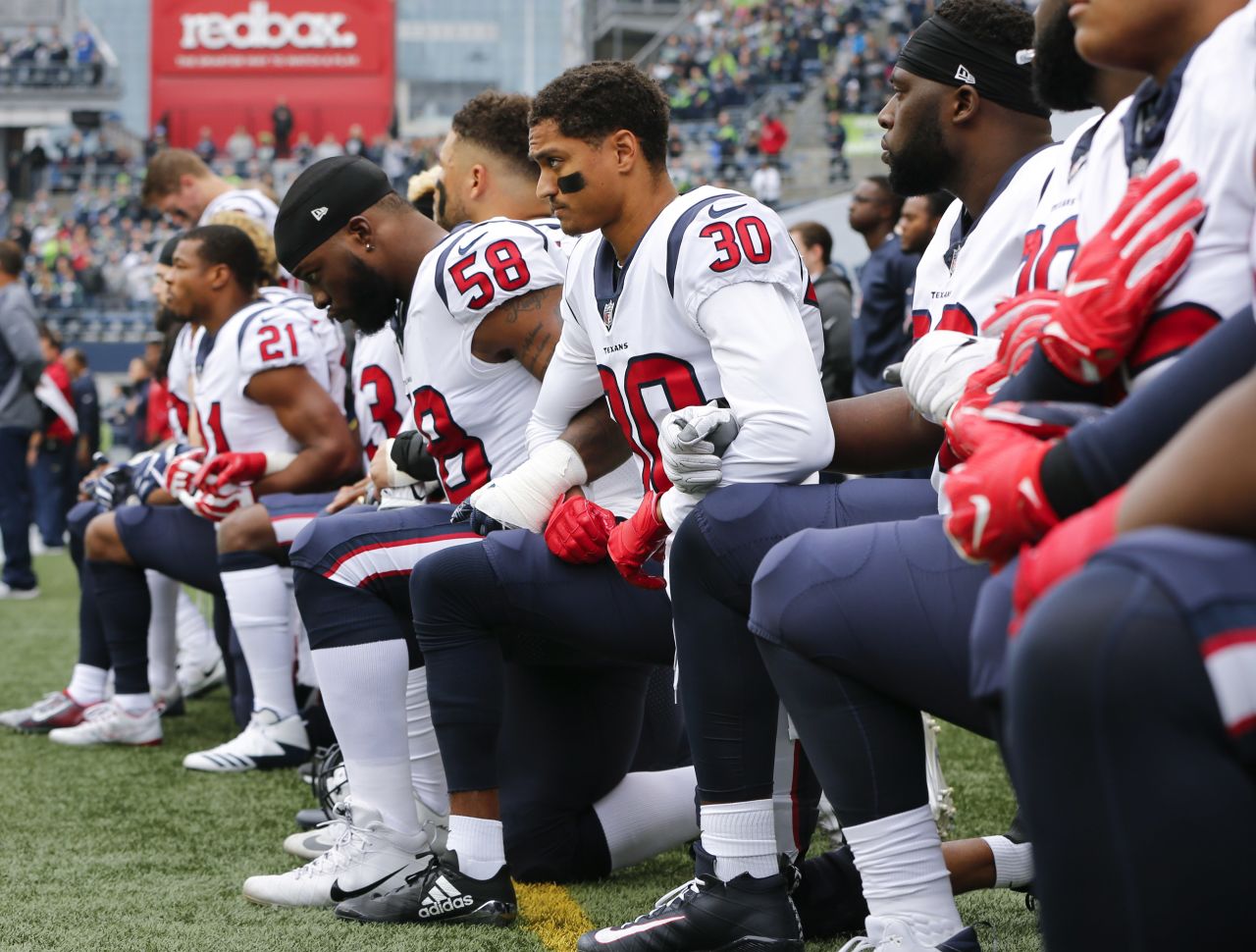 Members of the Houston Texans kneel during the National Anthem before the game at CenturyLink Field on October 29 in Seattle.