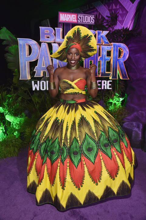 Actor Janeshia Adams-Ginyard is one of the Dora Milaje warriors of Wakanda. She looks radiant in full skirt and crop top made from multicolored Ankara, and with matching hat and head wrap Janeshia took the theme a step forward.