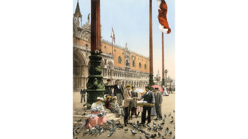 <strong>1. Southern and Western Europe:</strong> Photographers traveled to hotspots such as Venice and Jerusalem to take portraits of tourists, and many visitors purchased images to add to albums of their trips. Seen here, tourists feed the pigeons in St. Mark's Square, a Venice tradition that was banned in 2008.