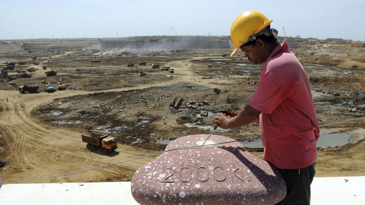 Construction workers operate heavy equipment at the base of Sri Lanka's Hambantota port August 1, 2010. Some 350 Chinese staff helped in the first phase of construction. 
