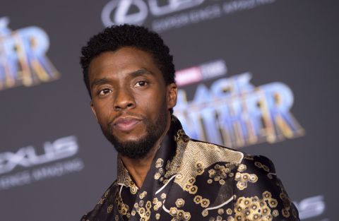 Chadwick Boseman is T'Challa (Black Panther), the king of Wakanda. His outfit is a silky black Emporio Armani jacket with intricate golden floral patterns.