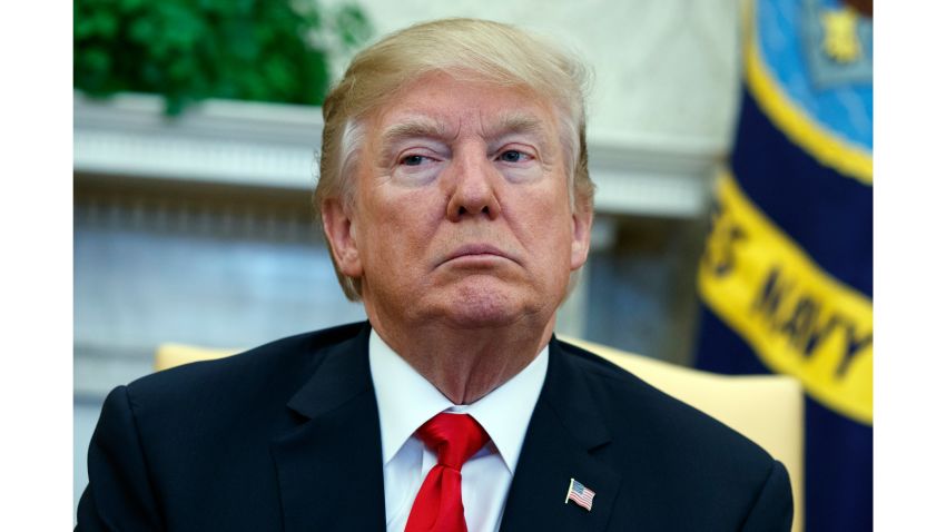 President Donald Trump listens during a meeting with North Korean defectors where he talked with reporters about allowing the release of a secret memo on the FBI's role in the Russia inquiry, in the Oval Office of the White House, Friday, Feb. 2, 2018, in Washington. (AP Photo/Evan Vucci)