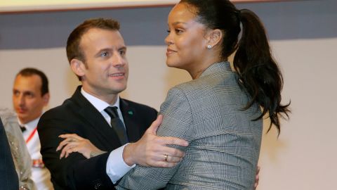 French President Emmanuel Macron embraces singer Rihanna as they attend the conference "GPE Financing Conference, an Investment in the Future" in Dakar on February 2, 2018, as part of Macron's visit to Senegal.
