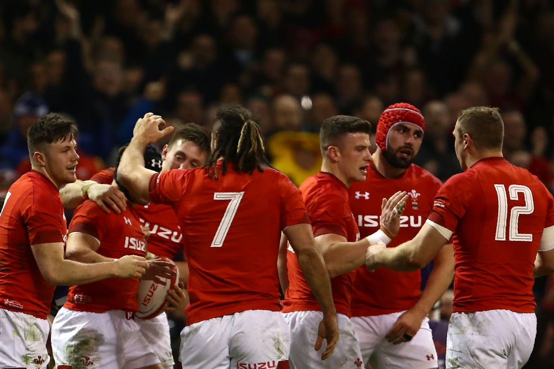 Wales players celebrate after scoring against Scotland.