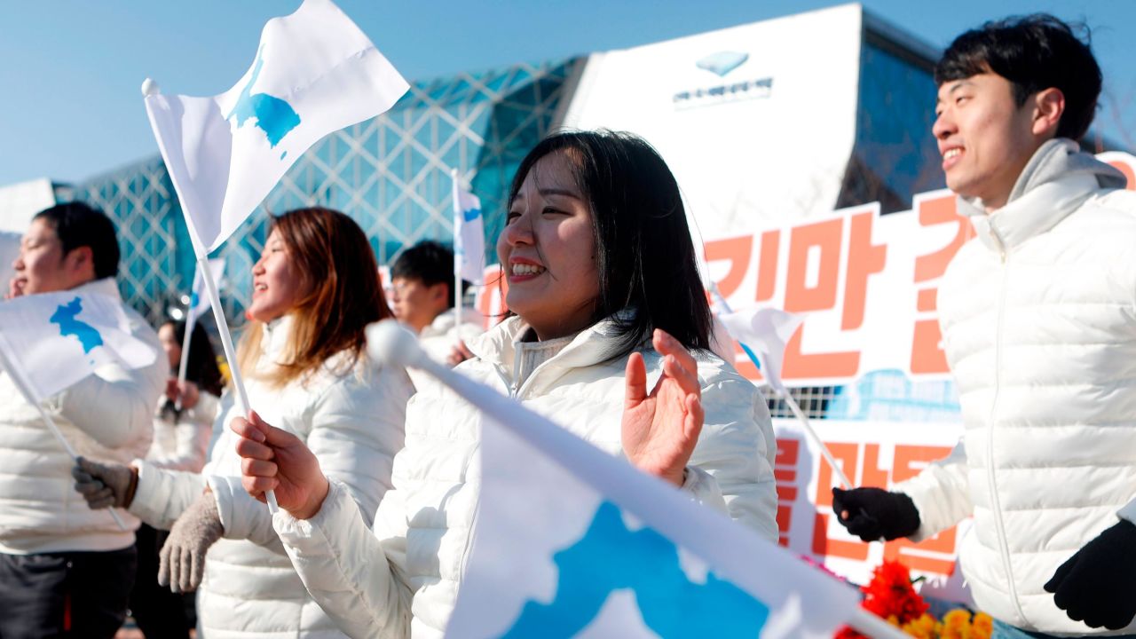 South Korean peace activists perform a welcoming dance before the match.