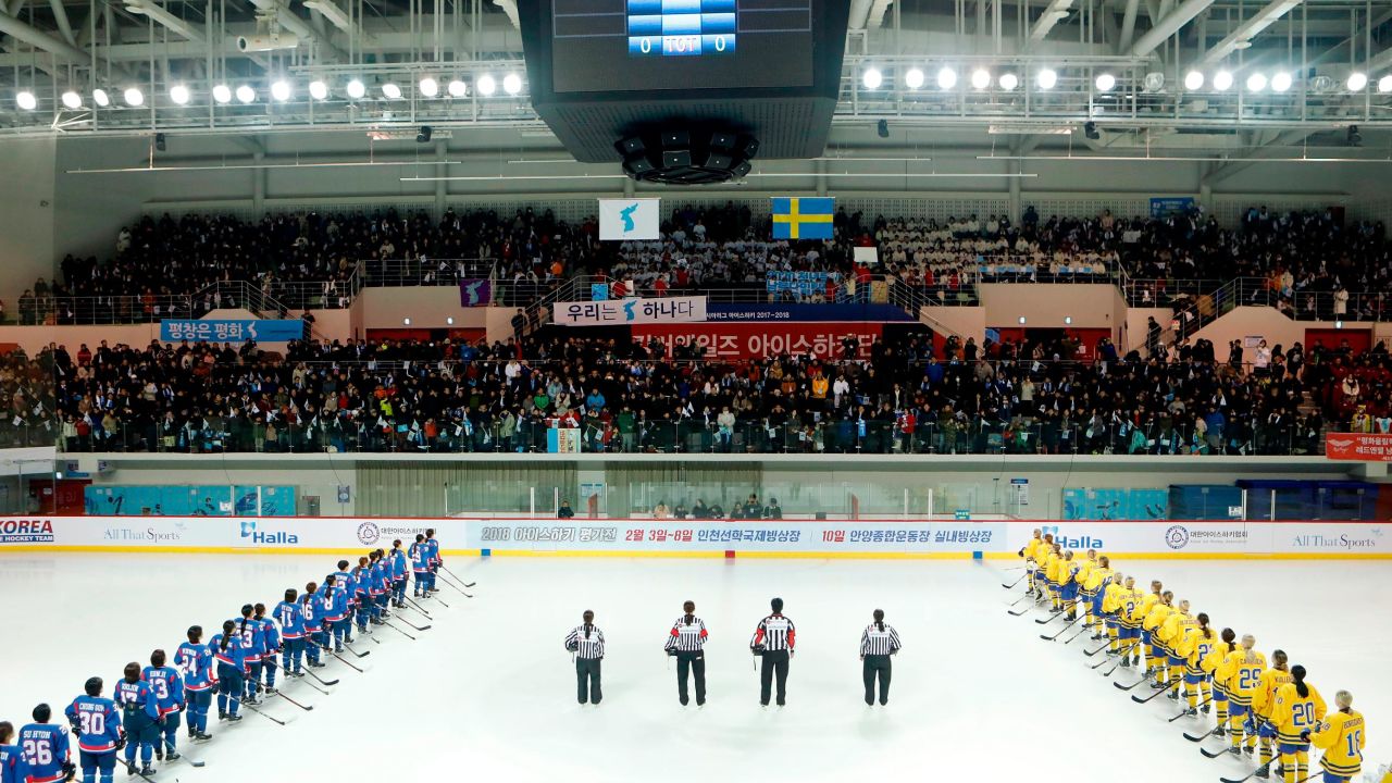 Athletes listen to Korean folk song "Arirang" during the friendly match.  