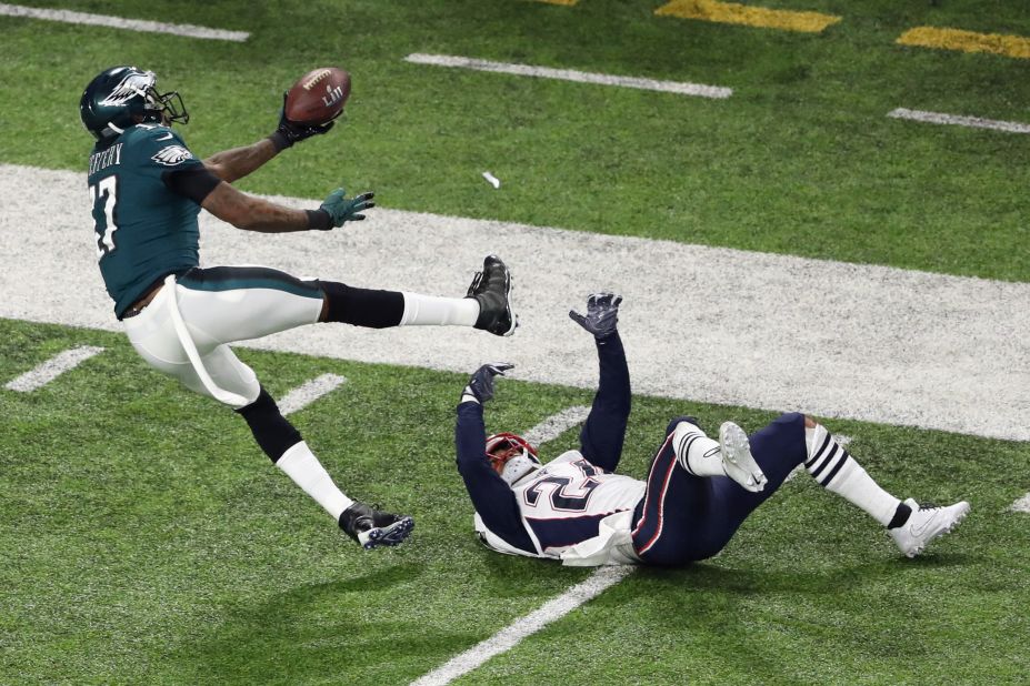 Philadelphia wide receiver Alshon Jeffery bobbles a pass that was intercepted by New England's Duron Harmon, not pictured.