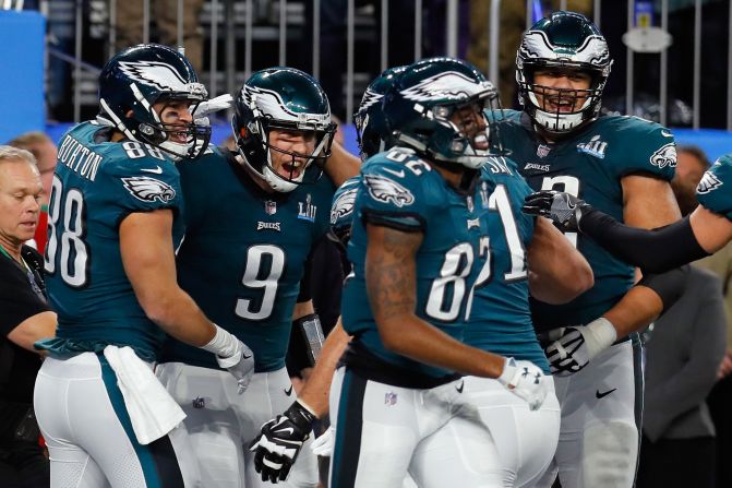 Foles is mobbed by teammates after his unlikely touchdown catch.