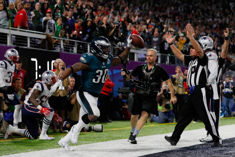 Philadelphia running back Corey Clement holds up the football after catching a 22-yard touchdown pass in the third quarter. The touchdown was held up after a video review, and Philadelphia took a 29-19 lead after the extra point.