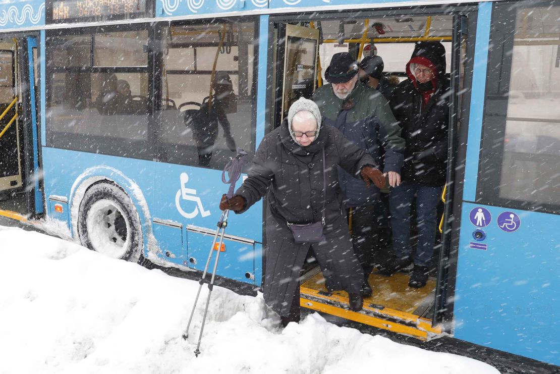 A passenger gingerly leaves a bus during the blizzard in Moscow.