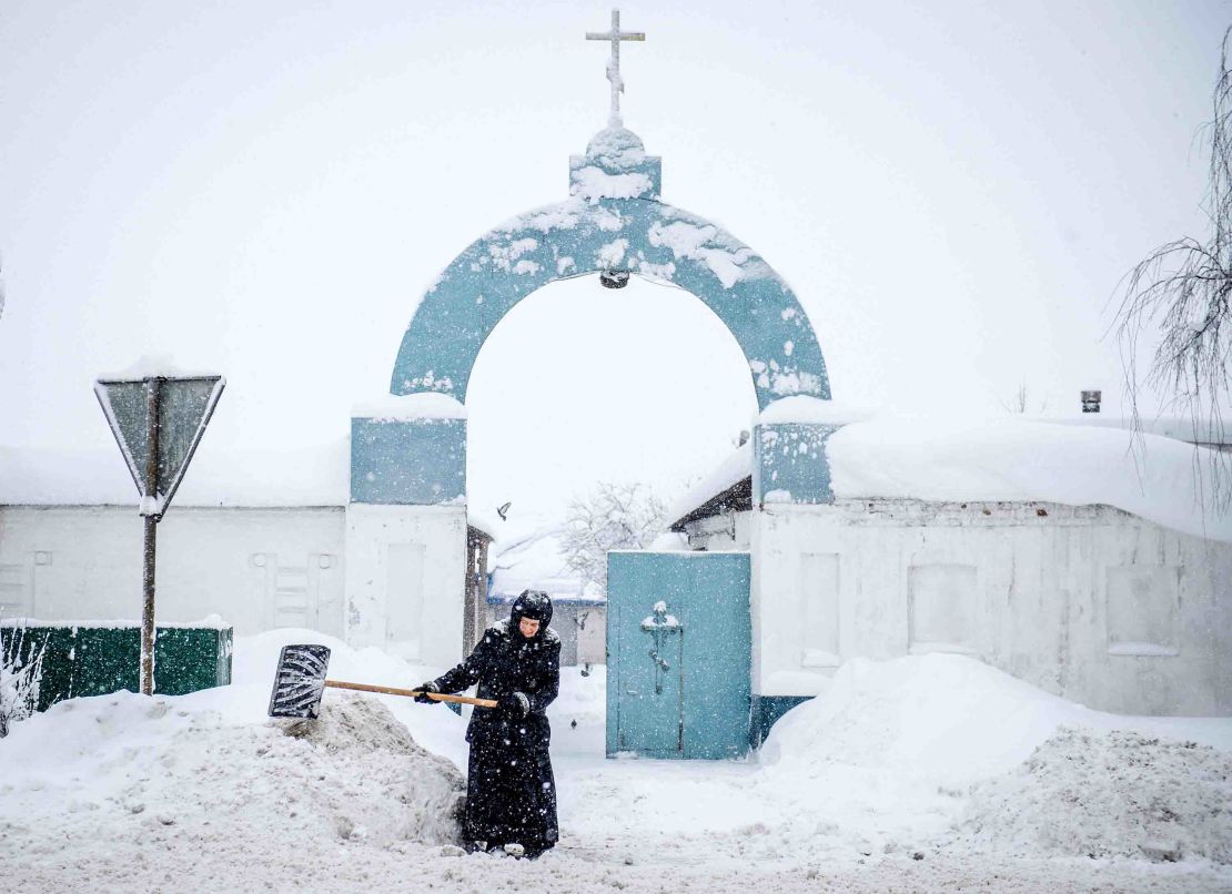A nun shovels snow in front of a nunnery in the village of Bogoslovo, 190km outside Moscow.