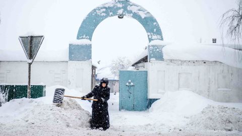A nun shovels snow in front of a nunnery in the village of Bogoslovo, 190km outside Moscow.