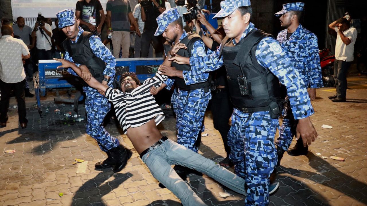 Maldivian police officers detain an opposition protestor demanding the release of political prisoners in Male on February 2.