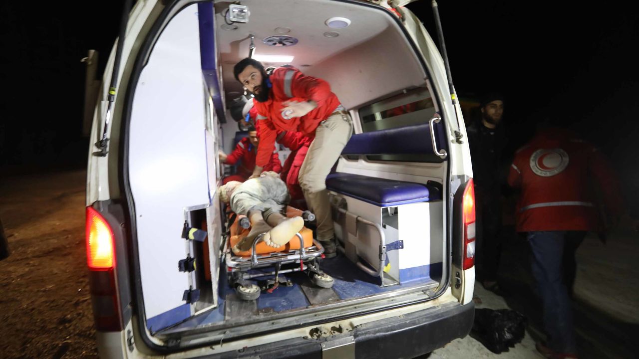 Rescuers treat a victim that was stuck under the rubble of the six-story building that collapsed in Idlib.