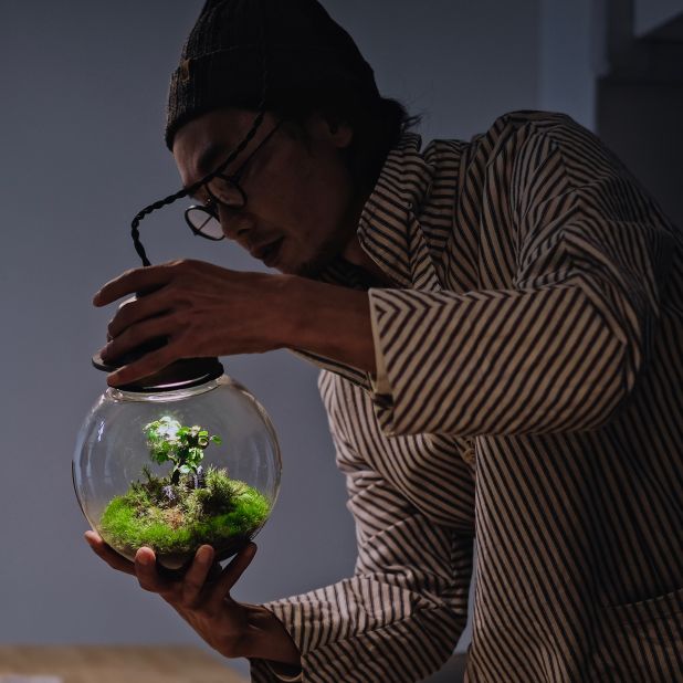 Murase opens a terrarium in his studio north of Kyoto. Murase's terrariums are low maintenance and only need to be watered once or twice a week, depending on the plants used.