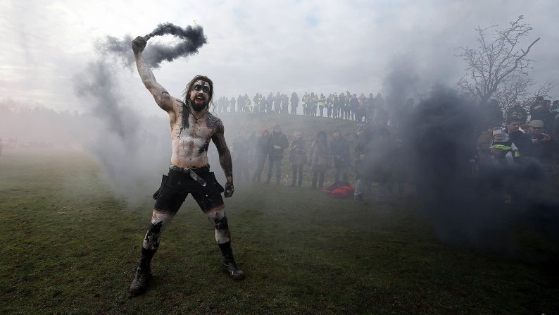 A competitor holds a smoke flare Sunday, February 4, ahead of the Tough Guy Mudathon event in Perton, England. The obstacle race raises money for charity.