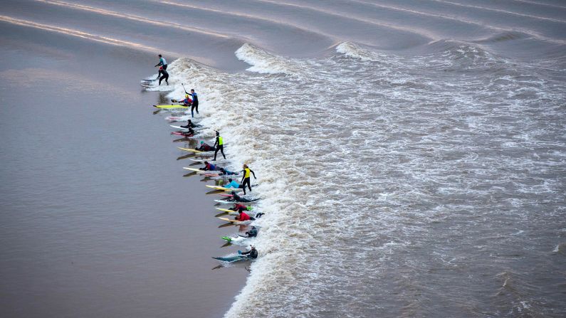 Surfers, paddleboarders and kayakers ride the <a href="index.php?page=&url=http%3A%2F%2Fwww.severn-bore.co.uk%2Findex.html" target="_blank" target="_blank">Severn tidal bore</a> in Gloucestershire, England, on Friday, February 2. The bore is one of the longest in the world.
