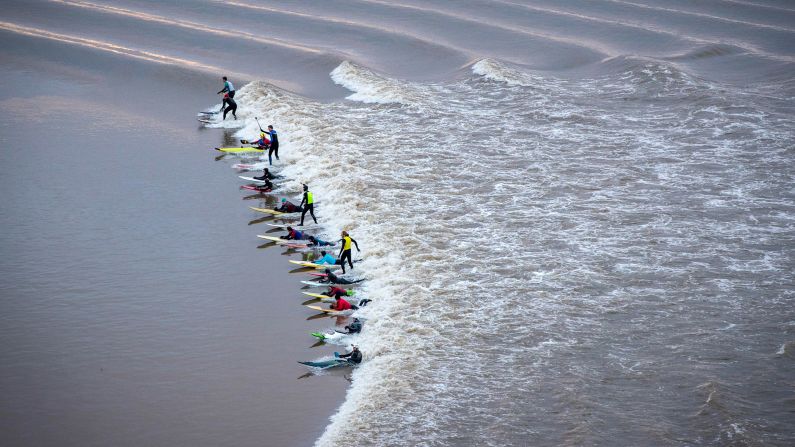 Surfers, paddleboarders and kayakers ride the <a  target="_blank" target="_blank">Severn tidal bore</a> in Gloucestershire, England, on Friday, February 2. The bore is one of the longest in the world.